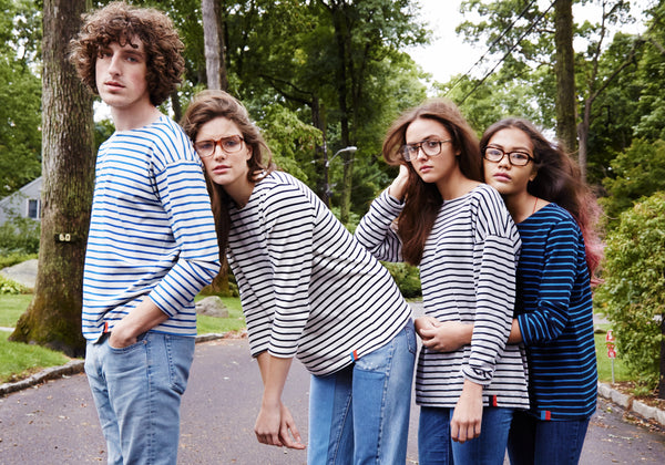 1 Male model and 3 female models wearing striped tees and jeans in the driveway