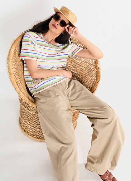 Model wearing The Striped Modern - Rainbow Multistripe and The Clyde Pants - Sand