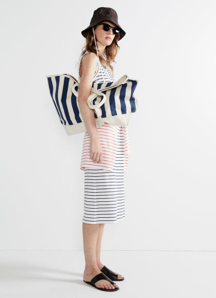 Model wearing The Tank Dress - White/Navy Pinstripe and holding The Over The Shoulder All Over Striped Tote - Canvas/Navy