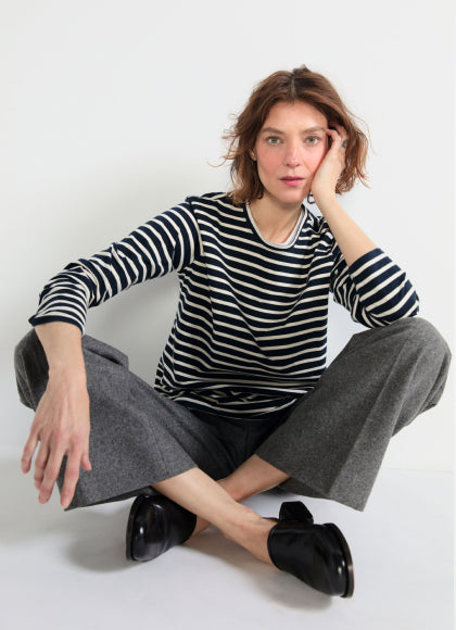 Model sitting cross legged on the ground while wearing The Modern Long - Navy/Cream