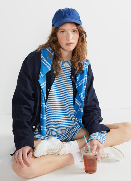 Model sitting while wearing The Peyton - Royal Blue/White and The Agnes - Royal Blue/White