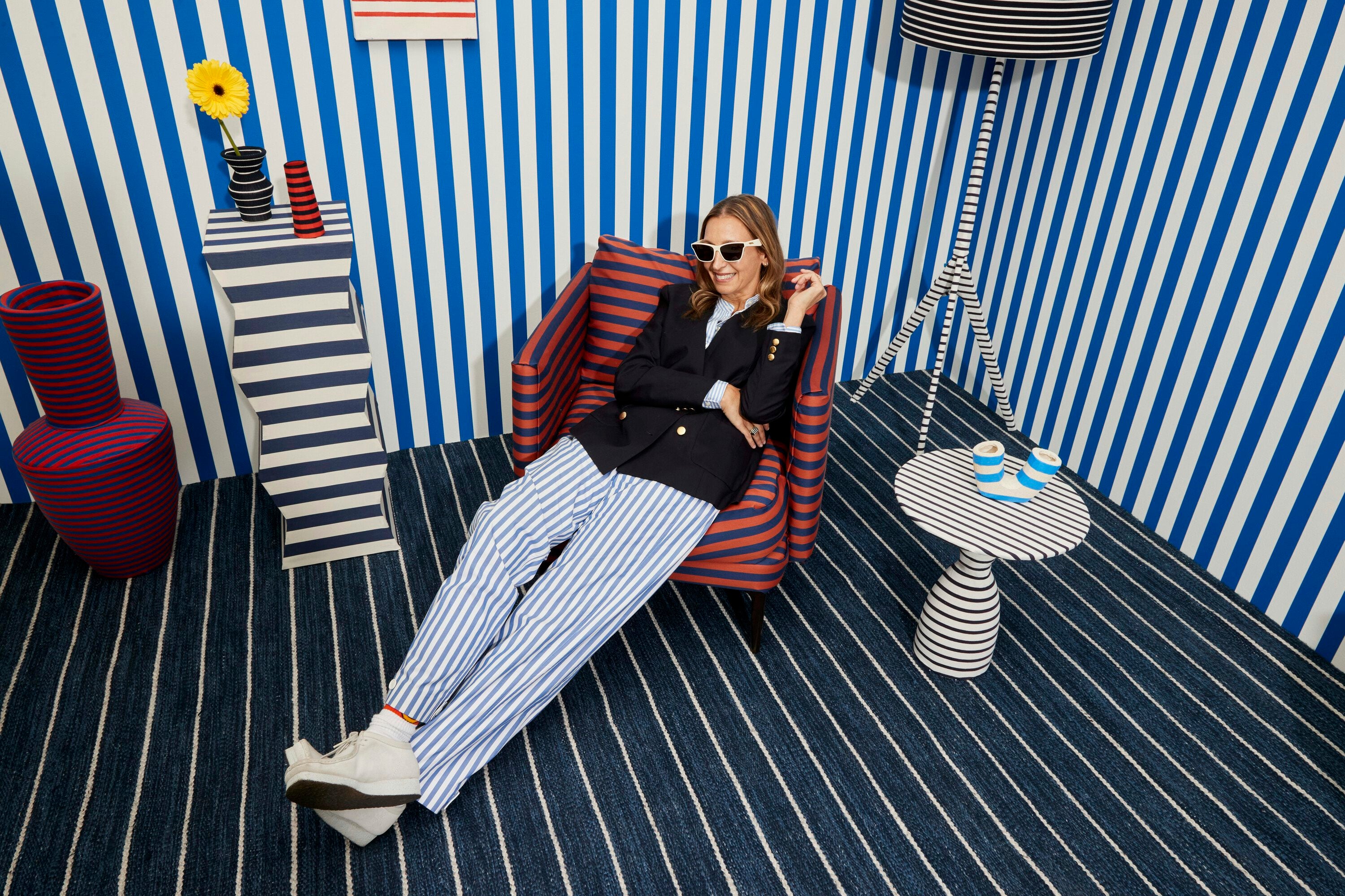Kule model wearing stripes inside a striped room